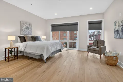 a bedroom with a bed and a chair