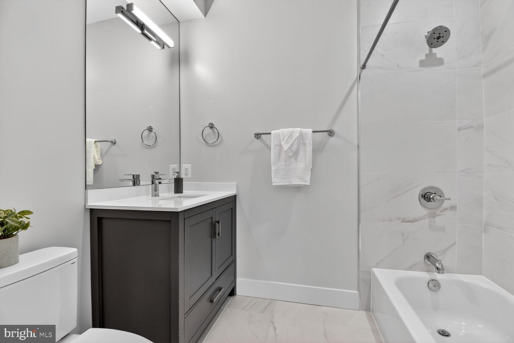 3532 1/2 13th Street Northwest, Unit 2 Washington, DC 20010 - Photo 28 of 38 a bathroom with a sink a toilet and shower