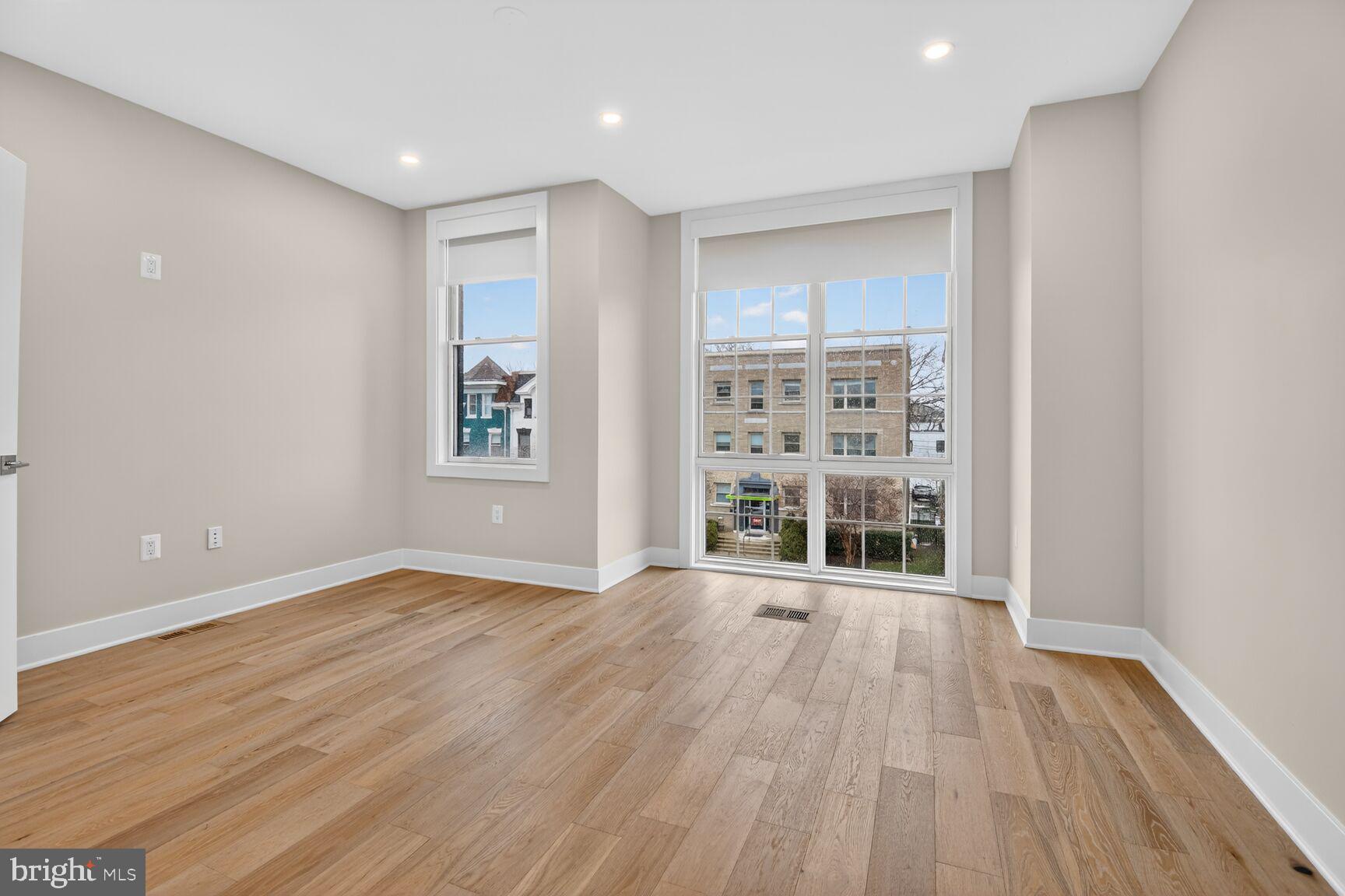 3532 1/2 13th Street Northwest, Unit 2 Washington, DC 20010 - Photo 29 of 38 a view of an empty room with wooden floor and a window
