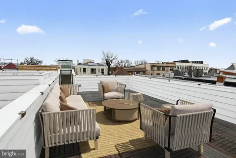a view of roof deck with seating space and a barbeque