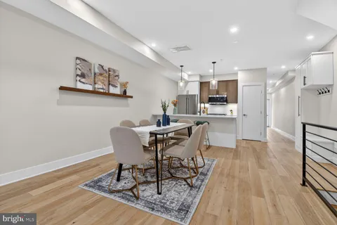a dining room with furniture and wooden floor