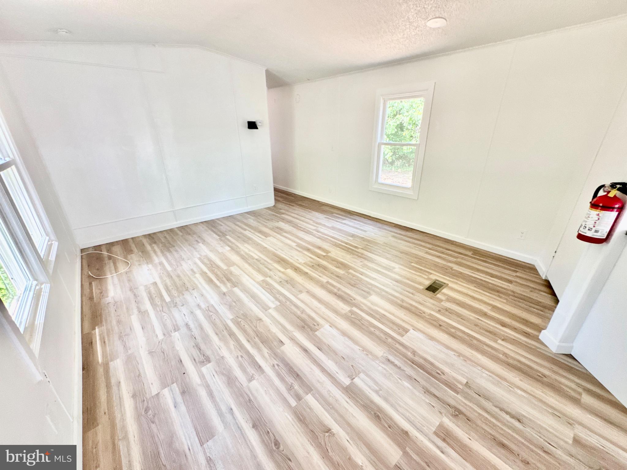 448 Evergreen Road Millville, NJ 08332 - Photo 12 of 25 a view of an empty room with wooden floor and a window