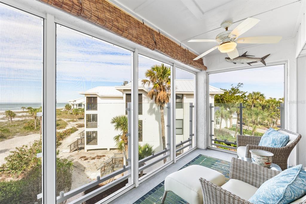 5000 Gasparilla Road, Unit DC307 Boca Grande, FL 33921 - Photo 11 of 33 a living room with furniture and a floor to ceiling window