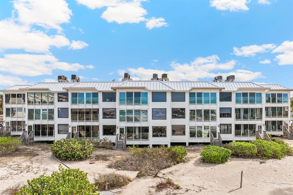 5000 Gasparilla Road, Unit DC307 Boca Grande, FL 33921 - Photo 2 of 33 a front view of a building with a garden