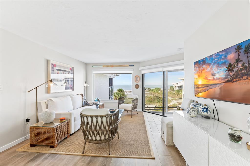 5000 Gasparilla Road, Unit DC307 Boca Grande, FL 33921 - Photo 3 of 33 a living room with furniture and a floor to ceiling window