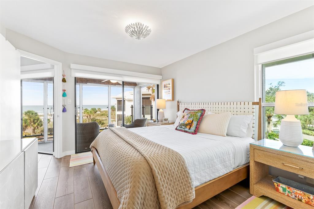 5000 Gasparilla Road, Unit DC307 Boca Grande, FL 33921 - Photo 7 of 33 a bedroom with a large bed and a chandelier