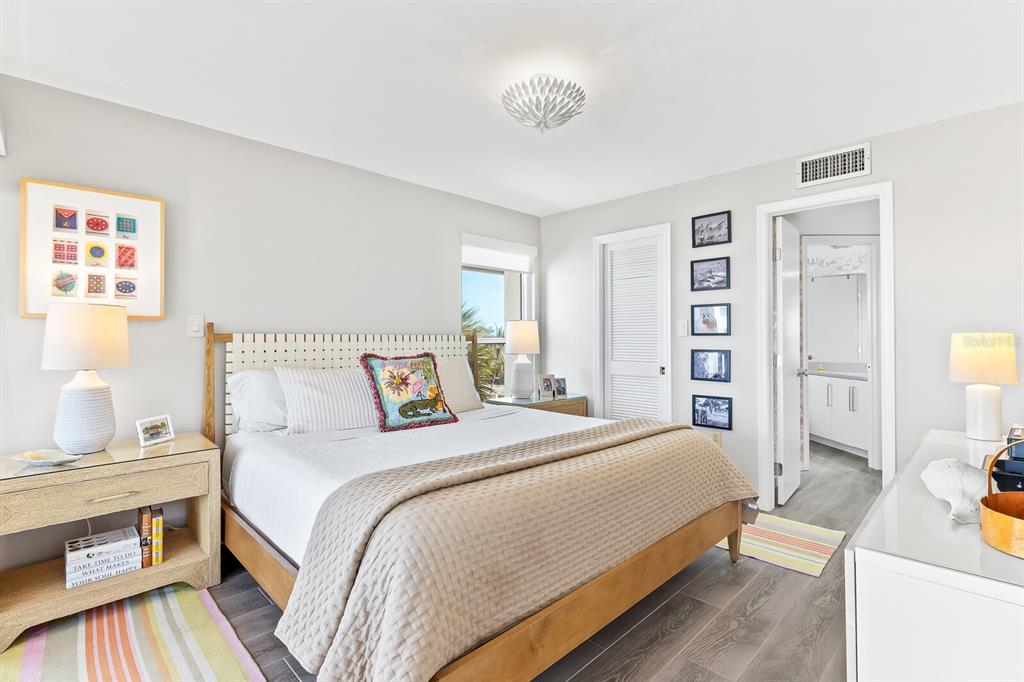 5000 Gasparilla Road, Unit DC307 Boca Grande, FL 33921 - Photo 8 of 33 a bedroom with a bed and wooden floor