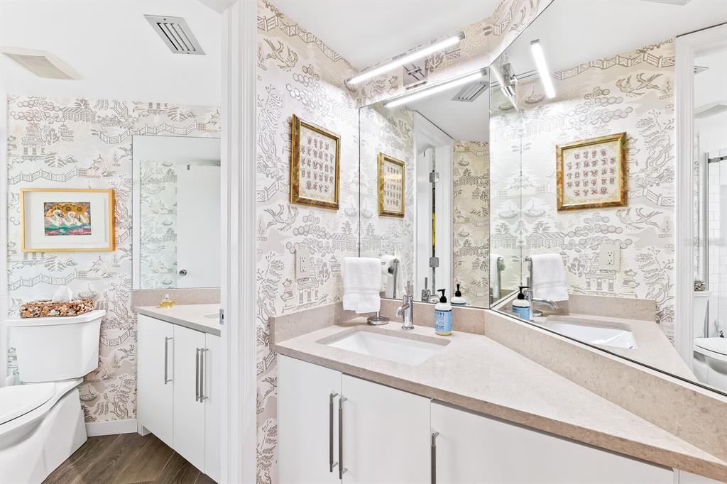 5000 Gasparilla Road, Unit DC307 Boca Grande, FL 33921 - Photo 9 of 33 a bathroom with a sink a toilet a mirror and vanity