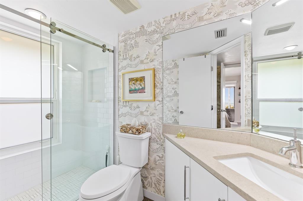 5000 Gasparilla Road, Unit DC307 Boca Grande, FL 33921 - Photo 10 of 33 a bathroom with a sink toilet vanity and shower