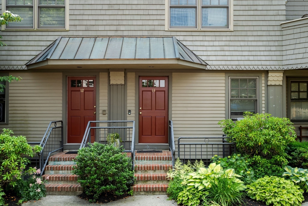 a front view of a house with plants