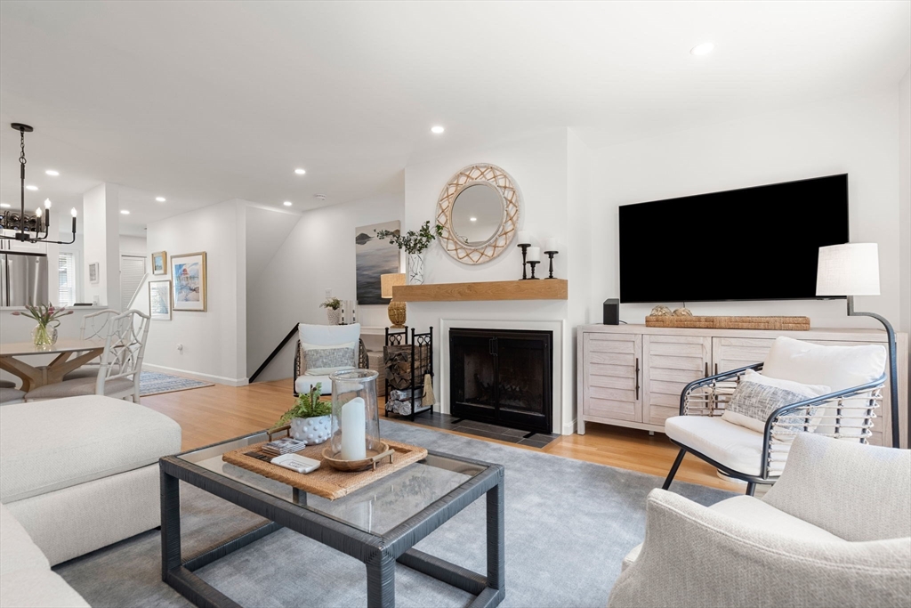 27 R West Street, Unit 13 Beverly, MA 01915 - Photo 13 of 34 a living room with furniture a fireplace and a flat screen tv