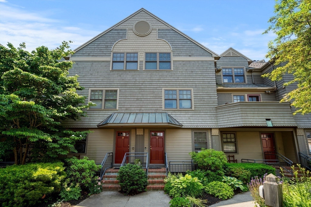 27 R West Street, Unit 13 Beverly, MA 01915 - Photo 16 of 34 a front view of a house with trees