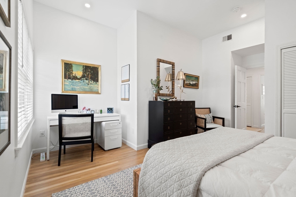 27 R West Street, Unit 13 Beverly, MA 01915 - Photo 17 of 34 a bedroom with a bed and a computer on a table