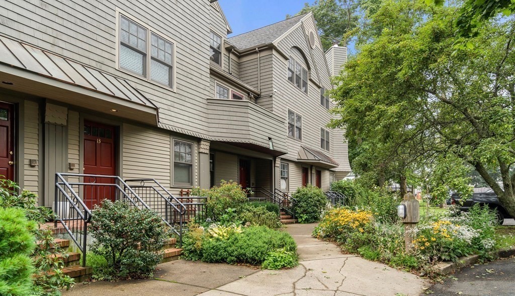 27 R West Street, Unit 13 Beverly, MA 01915 - Photo 2 of 34 a front view of a house with plants