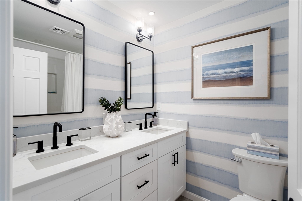 27 R West Street, Unit 13 Beverly, MA 01915 - Photo 21 of 34 a bathroom with double vanity sink and a mirror