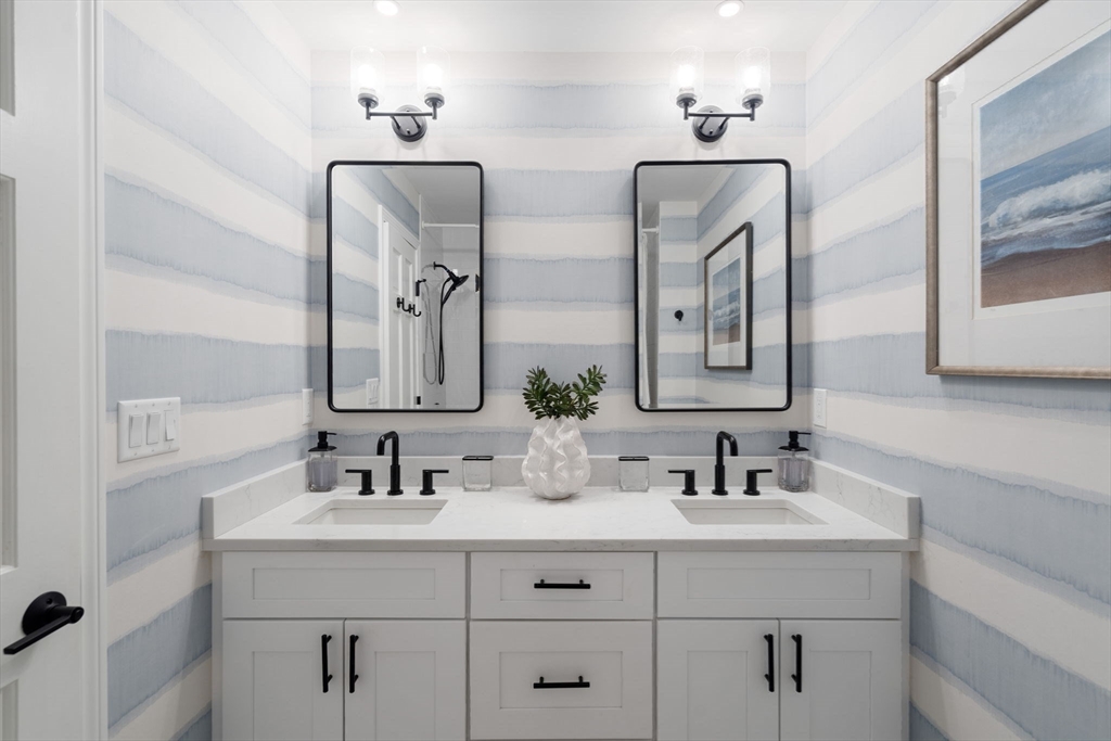 27 R West Street, Unit 13 Beverly, MA 01915 - Photo 23 of 34 a bathroom with double vanity sinks double vanity and a mirror