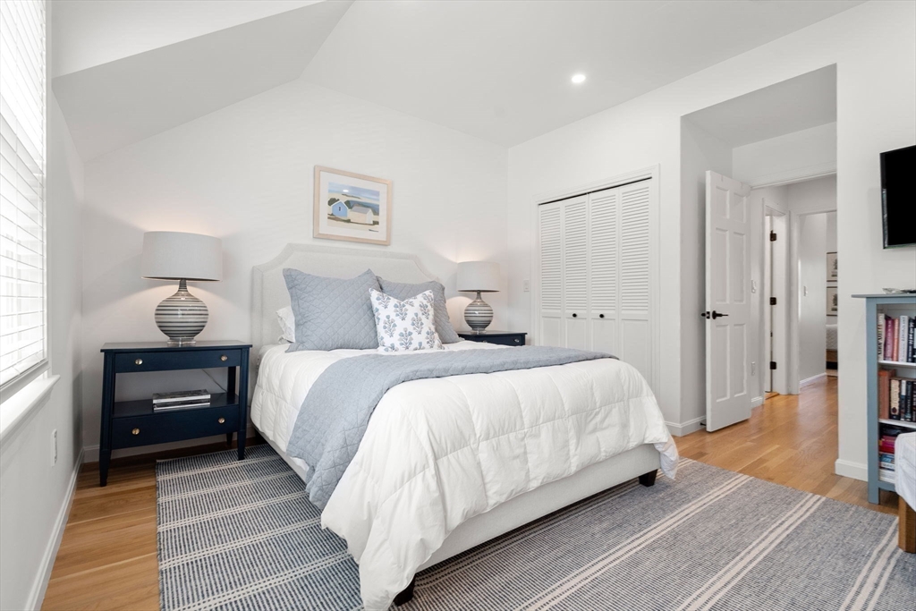 27 R West Street, Unit 13 Beverly, MA 01915 - Photo 26 of 34 a bedroom with bed and a table