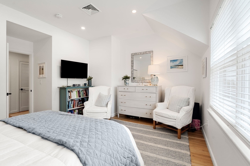 27 R West Street, Unit 13 Beverly, MA 01915 - Photo 27 of 34 a bedroom with a bed and flat screen tv