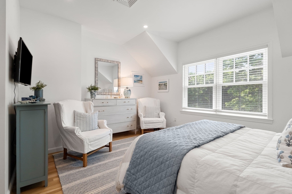 27 R West Street, Unit 13 Beverly, MA 01915 - Photo 28 of 34 a bedroom with a bed and a flat screen tv