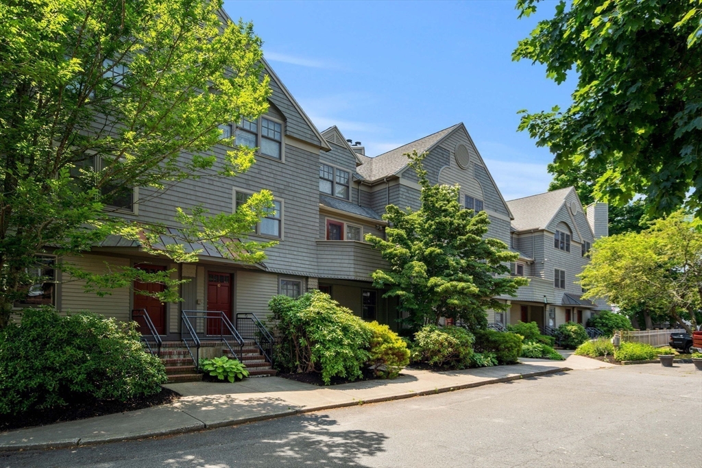 27 R West Street, Unit 13 Beverly, MA 01915 - Photo 30 of 34 a view of a street with a building and trees in the background