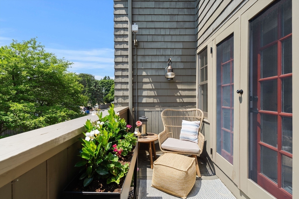 27 R West Street, Unit 13 Beverly, MA 01915 - Photo 32 of 34 a view of a chair and table in the balcony