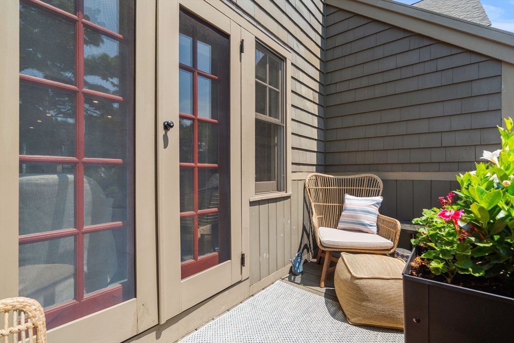 27 R West Street, Unit 13 Beverly, MA 01915 - Photo 33 of 34 a view of a house with a potted plant and floor to ceiling window