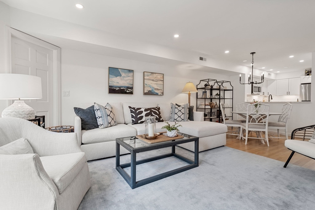 27 R West Street, Unit 13 Beverly, MA 01915 - Photo 6 of 34 a living room with furniture and a wooden floor