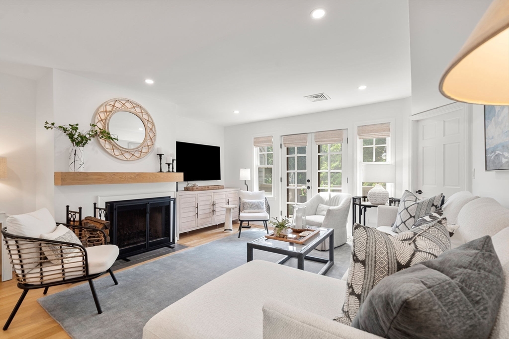 27 R West Street, Unit 13 Beverly, MA 01915 - Photo 8 of 34 a living room with furniture a fireplace and a flat screen tv