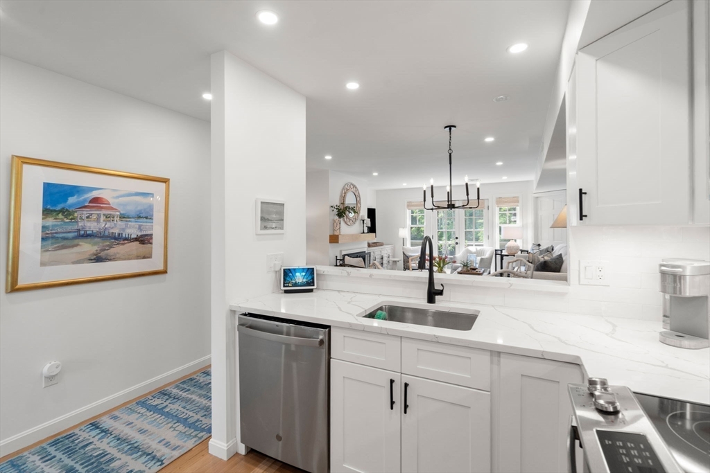 27 R West Street, Unit 13 Beverly, MA 01915 - Photo 10 of 34 a kitchen with stainless steel appliances a sink a stove a refrigerator and cabinets