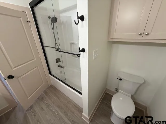 a bathroom with a toilet and a shower