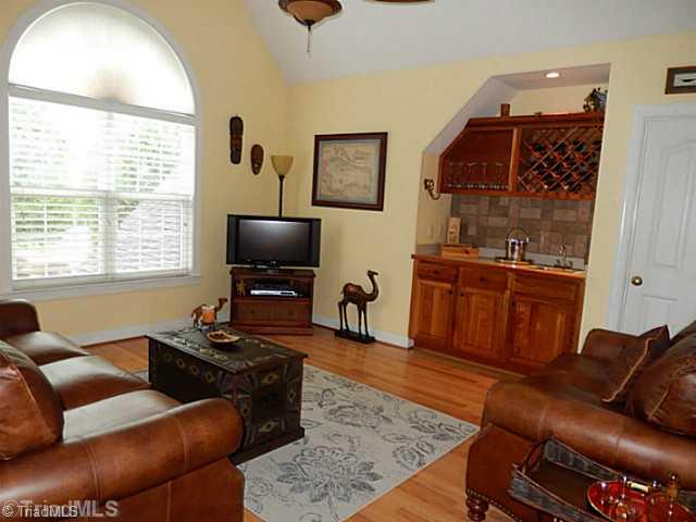 7802 Wilson Farm Road Summerfield, NC 27358 - Photo 14 of 16 Loft. Loft/Bonus Room with wetbar, beautiful natural lighting and hardwood floors with door access great walk in storage