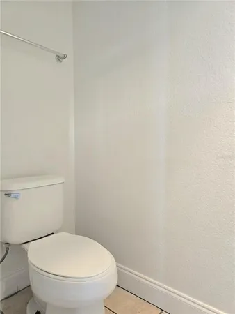 a white toilet sitting next to a shower