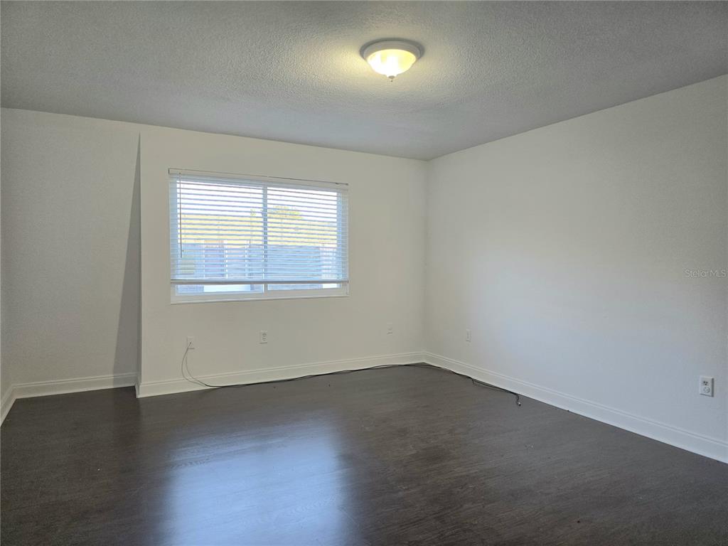 1930 South Conway Road, Unit 2 Orlando, FL 32812 - Photo 14 of 25 an empty room with wooden floor and windows