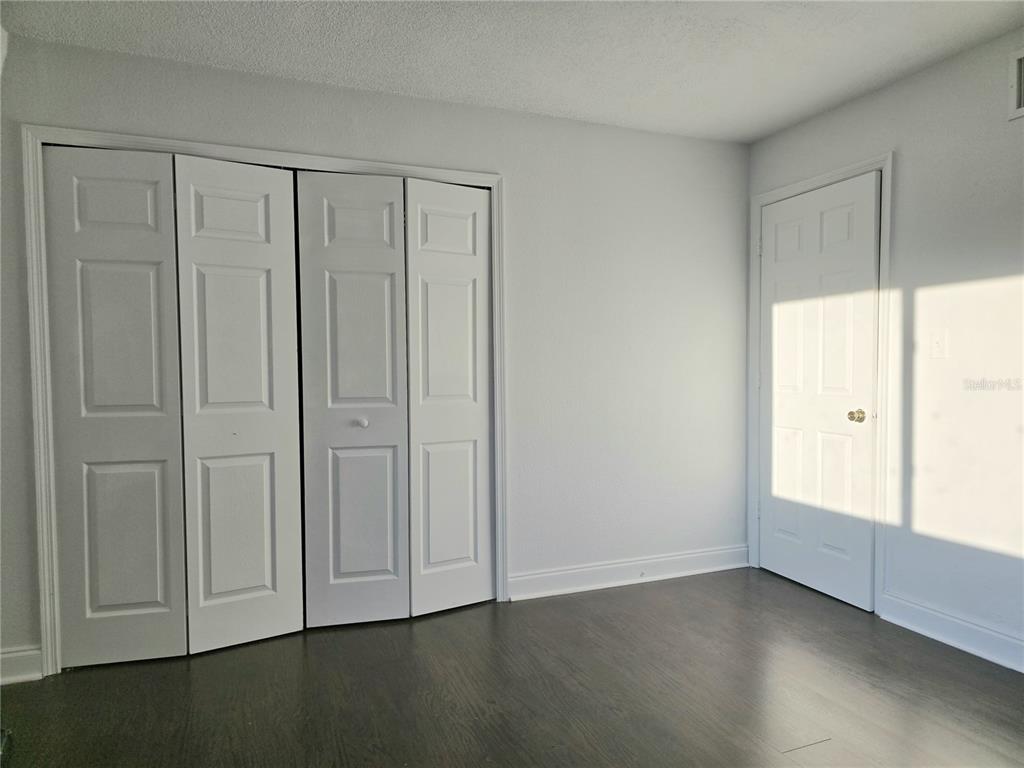 1930 South Conway Road, Unit 2 Orlando, FL 32812 - Photo 17 of 25 an empty room with wooden floor