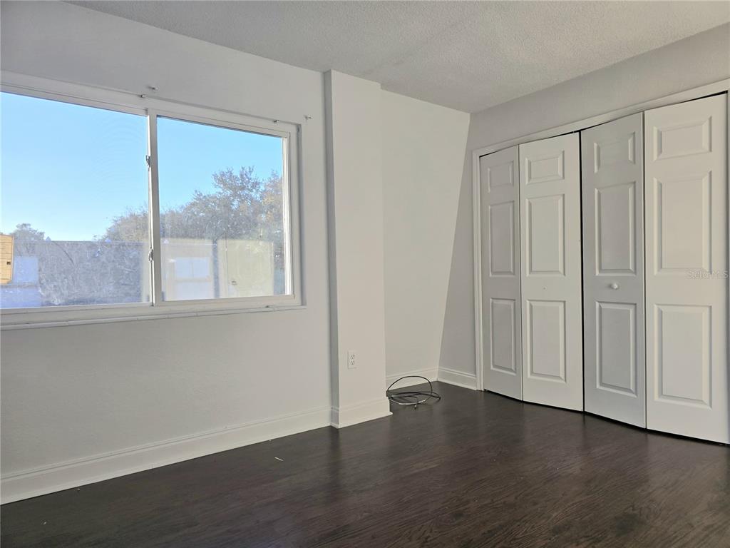 1930 South Conway Road, Unit 2 Orlando, FL 32812 - Photo 18 of 25 a view of an empty room with wooden floor and a window