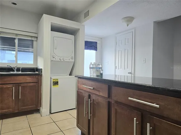 a kitchen with a sink appliances and cabinets