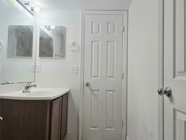 a bathroom with a sink and mirror