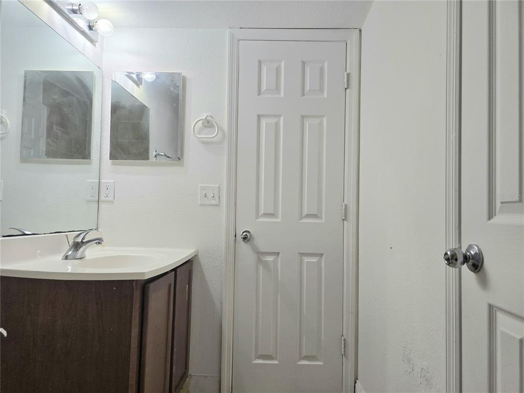 1930 South Conway Road, Unit 2 Orlando, FL 32812 - Photo 21 of 25 a bathroom with a sink and mirror