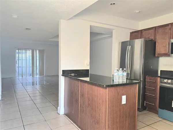 a kitchen with stainless steel appliances a refrigerator and a stove