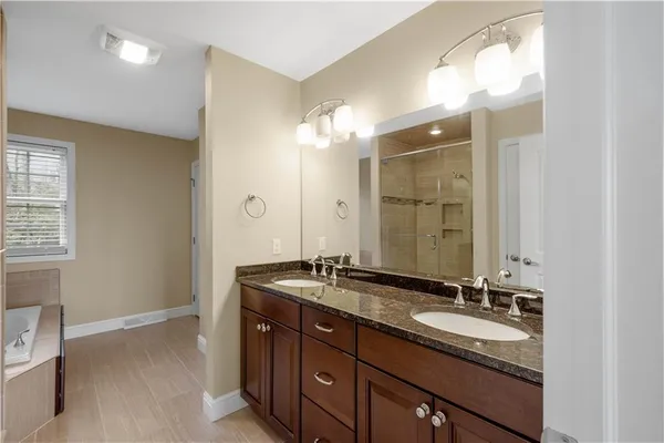 a bathroom with a sink double vanity and a mirror