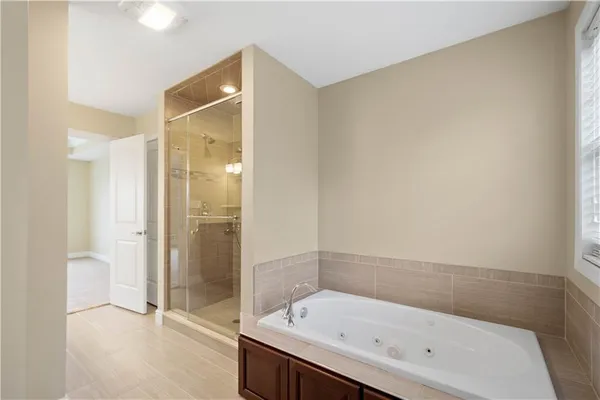 a bathroom with a bathtub and a shower