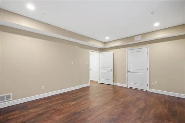 a backyard of white house with green space