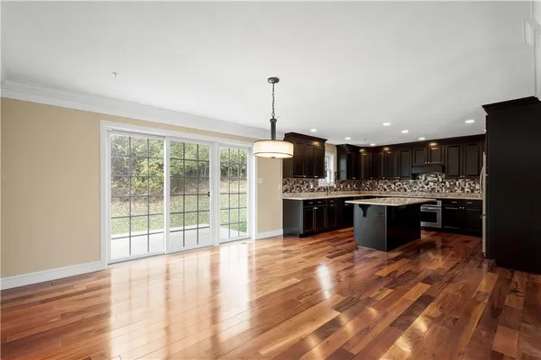 a kitchen with stainless steel appliances kitchen island granite countertop a stove top oven and cabinets