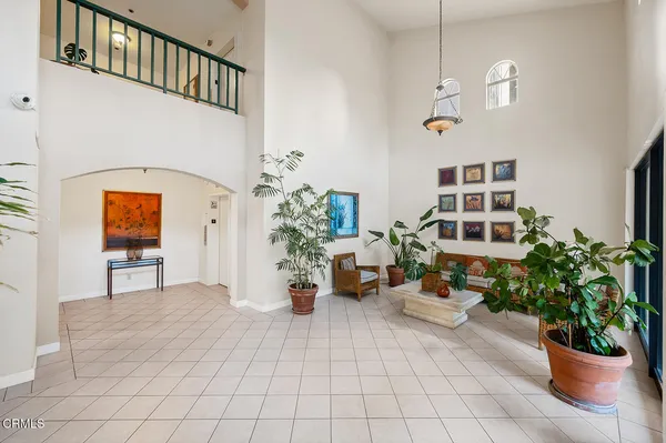 a view of a hallway with wooden floor and windows