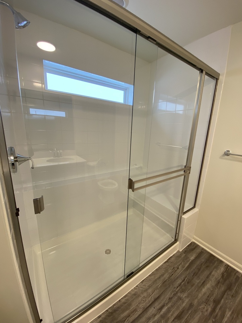1208 Draper Road McHenry, IL 60050 - Photo 13 of 22 a bathroom with a glass shower door