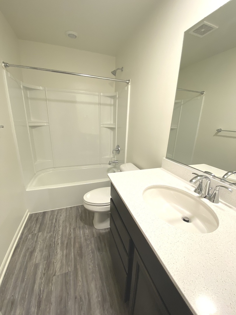 1208 Draper Road McHenry, IL 60050 - Photo 17 of 22 a bathroom with a sink a toilet and shower
