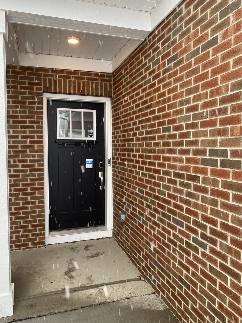 1208 Draper Road McHenry, IL 60050 - Photo 19 of 22 a view of a brick house with a door