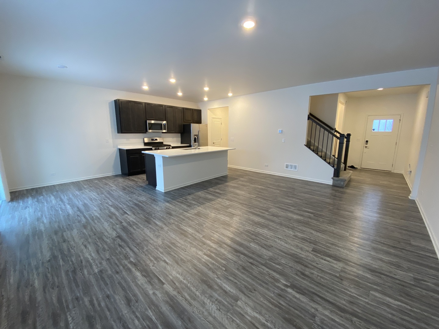 1208 Draper Road McHenry, IL 60050 - Photo 2 of 22 a view of a living room kitchen with furniture and wooden floor