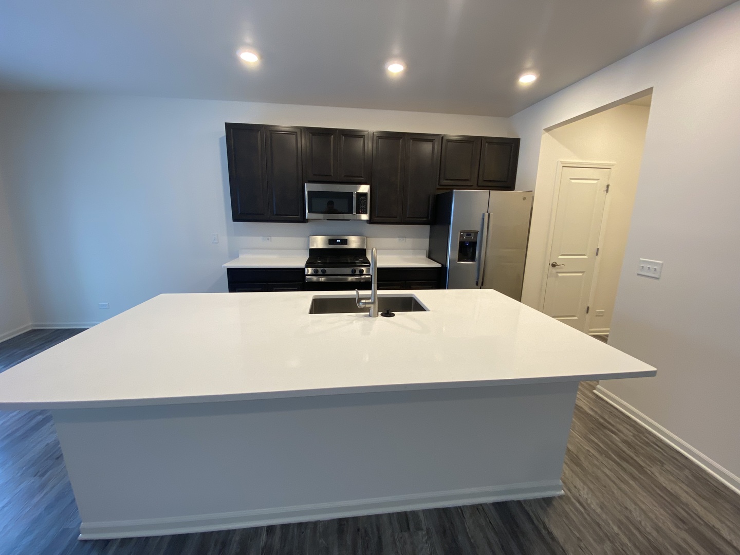 1208 Draper Road McHenry, IL 60050 - Photo 4 of 22 a large white kitchen with a sink and refrigerator