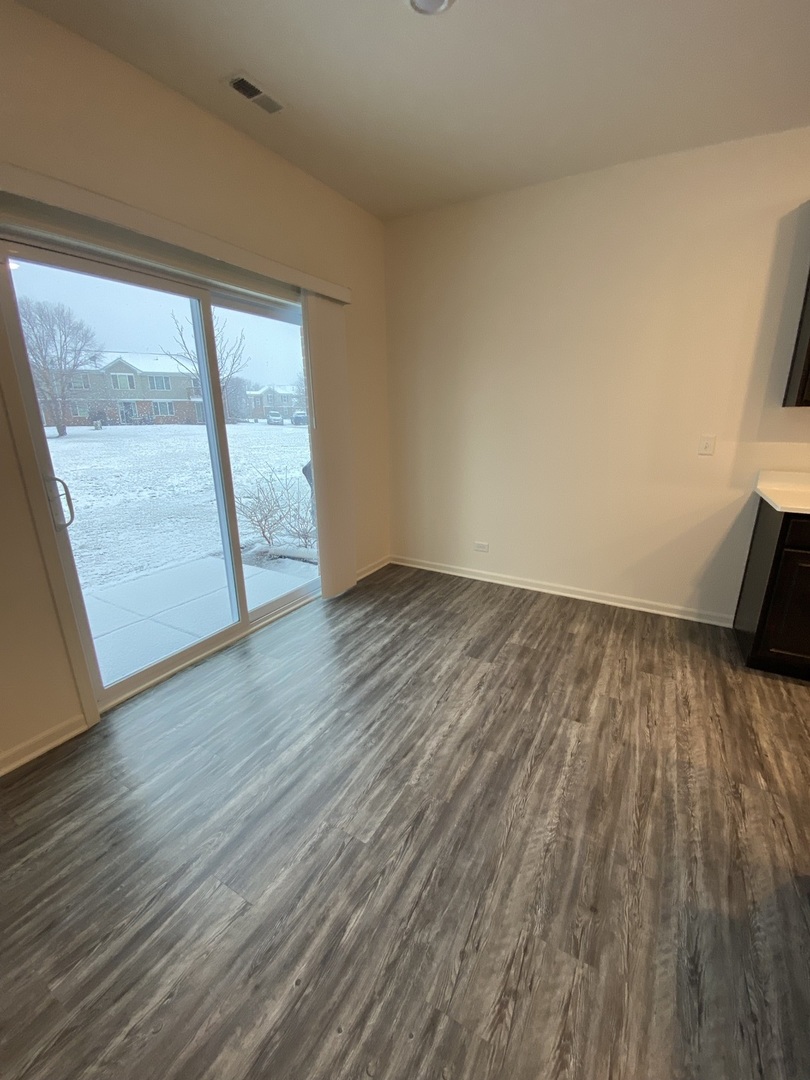 1208 Draper Road McHenry, IL 60050 - Photo 5 of 22 wooden floor in an empty room with a window